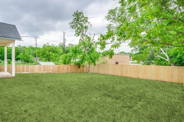view of yard with a fenced backyard
