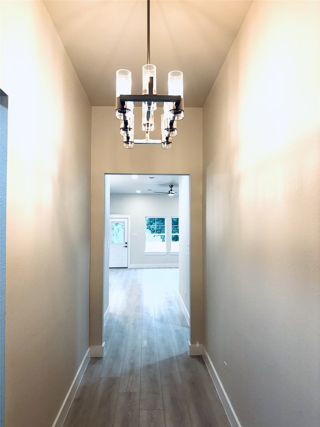 5632 Goodman Ave, Fort Worth, TX 76107 - corridor featuring a chandelier, dark wood-type flooring, and baseboards