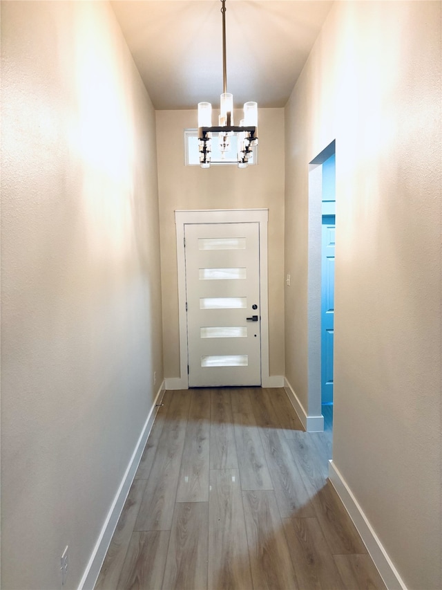 5632 Goodman Ave, Fort Worth, TX 76107 - doorway featuring a chandelier, wood finished floors, and baseboards