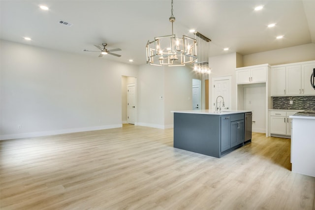 kitchen with recessed lighting, open floor plan, white cabinetry, and ceiling fan with notable chandelier
