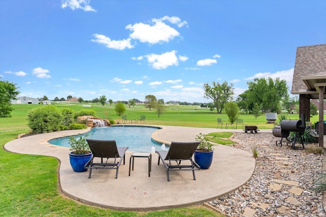 pool featuring a patio and a yard