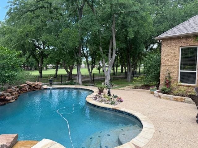 view of swimming pool featuring a fenced in pool, fence, and a patio