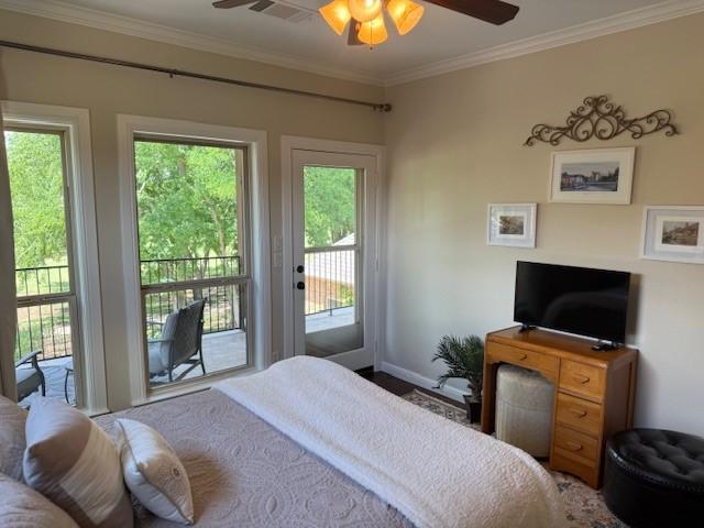 bedroom with crown molding, visible vents, multiple windows, and access to exterior