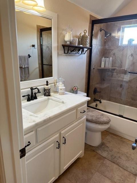bathroom featuring toilet, vaulted ceiling, bath / shower combo with glass door, and vanity