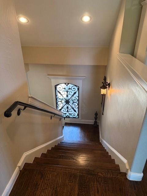 stairway featuring baseboards, recessed lighting, and wood finished floors