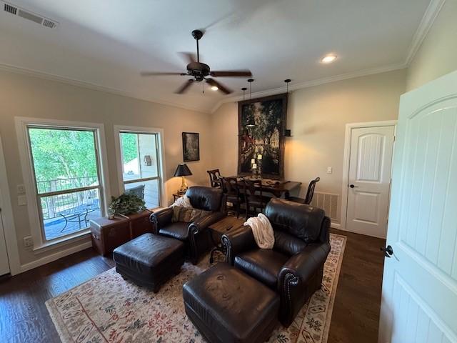 home theater room featuring ceiling fan, visible vents, dark wood-style floors, ornamental molding, and recessed lighting
