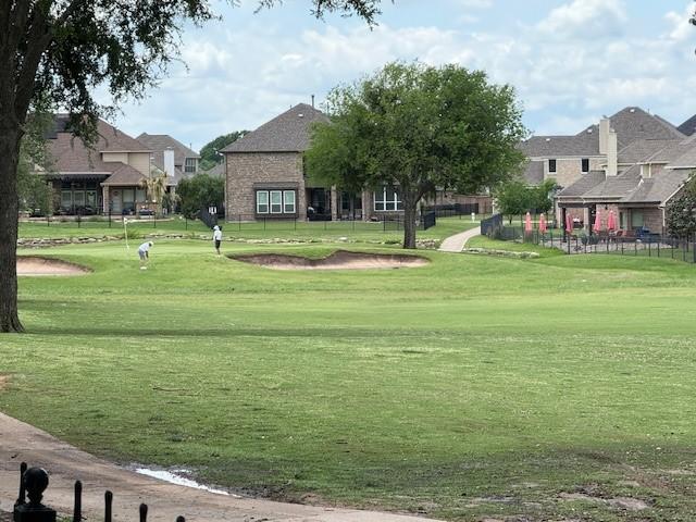 view of community featuring a lawn and a residential view