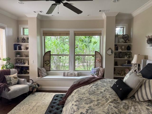 bedroom with visible vents, ornamental molding, and wood finished floors