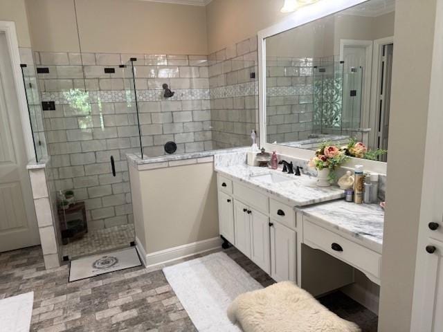 bathroom featuring vanity, ornamental molding, and a stall shower