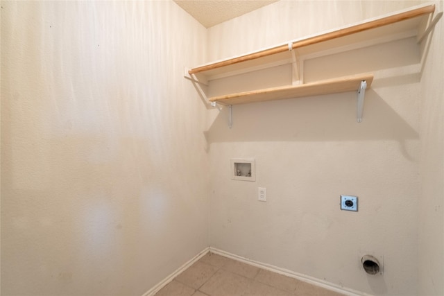 clothes washing area with laundry area, light tile patterned flooring, baseboards, washer hookup, and hookup for an electric dryer