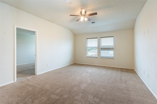 carpeted spare room featuring visible vents, a ceiling fan, baseboards, and a textured ceiling
