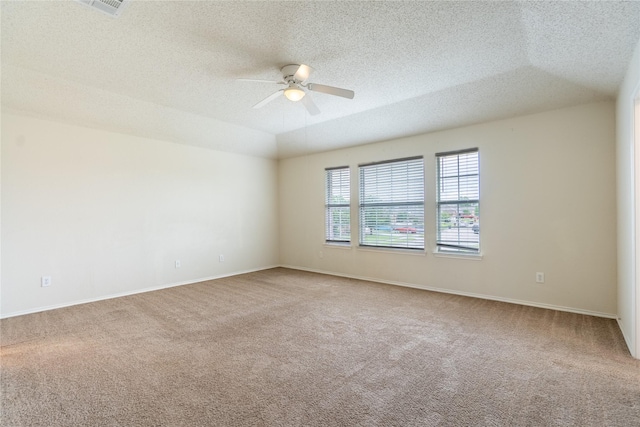 carpeted spare room with a textured ceiling, ceiling fan, and baseboards