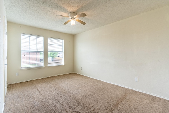 empty room featuring carpet floors, baseboards, a ceiling fan, and a textured ceiling