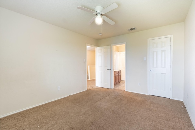 unfurnished bedroom featuring baseboards, visible vents, and light carpet