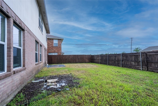 view of yard with a fenced backyard