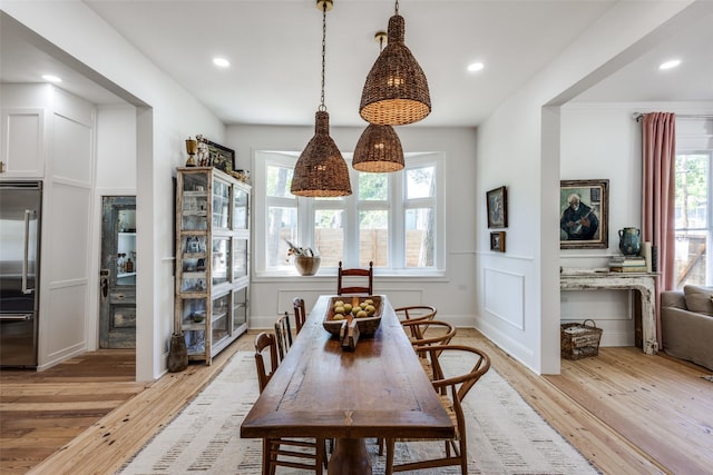 805 Howell St, Mckinney, TX 75069 - dining room with wainscoting, a decorative wall, recessed lighting, and light wood-style flooring