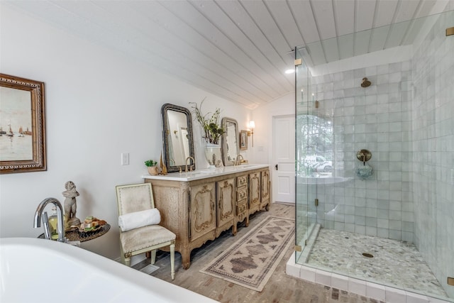 805 Howell St, Mckinney, TX 75069 - full bathroom featuring a stall shower, a freestanding bath, double vanity, lofted ceiling, and wood finished floors