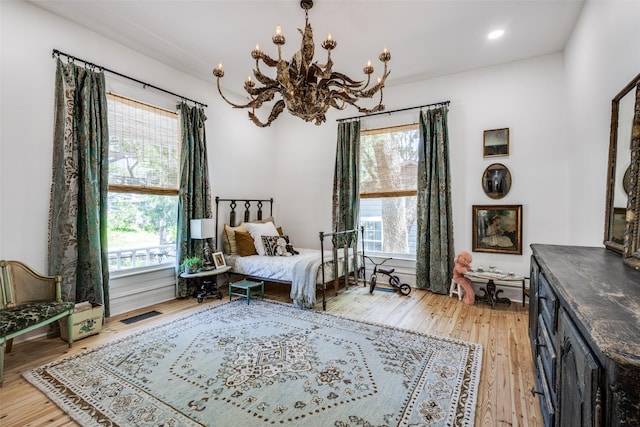 805 Howell St, Mckinney, TX 75069 - bedroom with multiple windows, a chandelier, light wood-style flooring, and recessed lighting