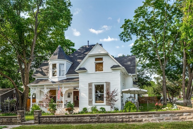 805 Howell St, Mckinney, TX 75069 - victorian house with covered porch, roof with shingles, and a fenced front yard