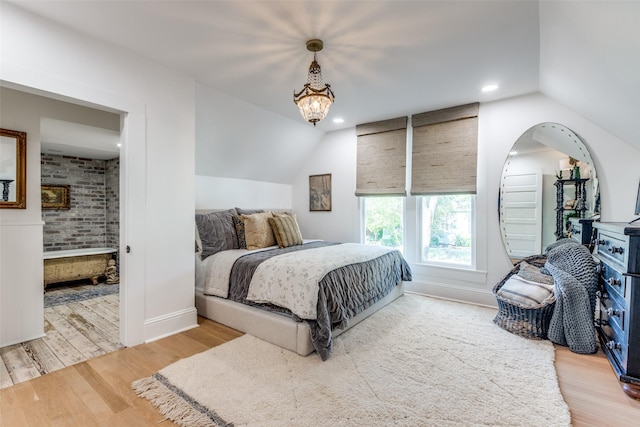 805 Howell St, Mckinney, TX 75069 - bedroom featuring wood finished floors, connected bathroom, and lofted ceiling
