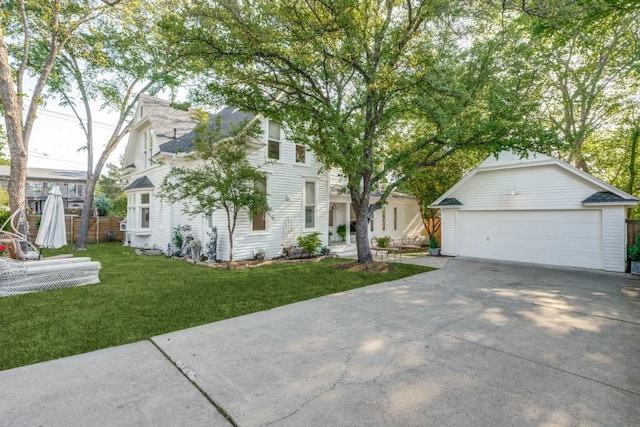 805 Howell St, Mckinney, TX 75069 - view of front of home with a detached garage, fence, an outdoor structure, and a front yard