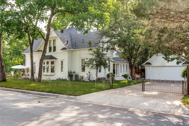 805 Howell St, Mckinney, TX 75069 - view of front of property featuring a garage, an outdoor structure, driveway, and roof with shingles