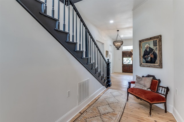 805 Howell St, Mckinney, TX 75069 - foyer featuring visible vents, an inviting chandelier, stairs, hardwood / wood-style floors, and baseboards