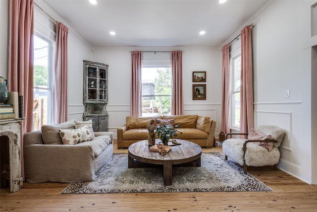805 Howell St, Mckinney, TX 75069 - living room featuring crown molding, wood finished floors, a decorative wall, recessed lighting, and wainscoting