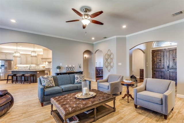 2417 Roosevelt Ave, Fort Worth, TX 76164 - living area featuring arched walkways, a ceiling fan, visible vents, and light wood finished floors