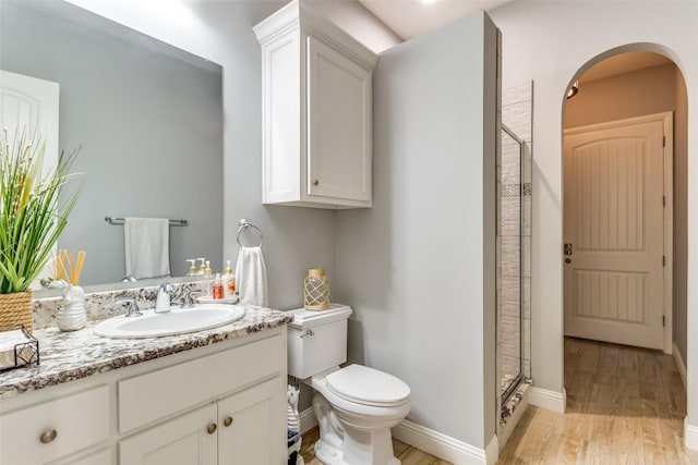 2417 Roosevelt Ave, Fort Worth, TX 76164 - bathroom featuring vanity, wood finished floors, toilet, and a shower stall