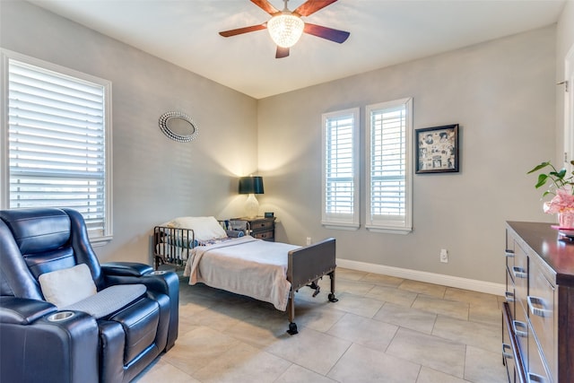 2417 Roosevelt Ave, Fort Worth, TX 76164 - bedroom with light tile patterned floors, baseboards, and ceiling fan