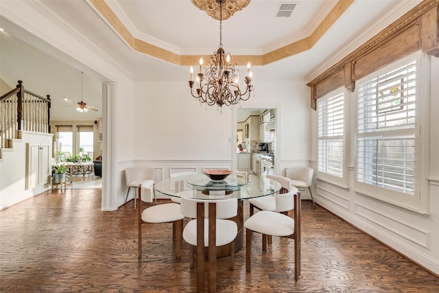 dining area featuring plenty of natural light, stairs, wood finished floors, and visible vents