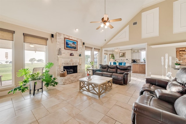 living room featuring crown molding, a fireplace, high vaulted ceiling, a ceiling fan, and visible vents