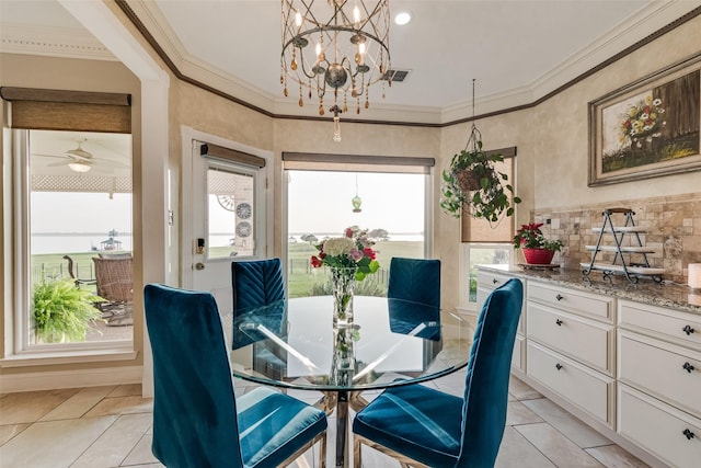 dining room featuring crown molding, visible vents, light tile patterned floors, and ceiling fan with notable chandelier