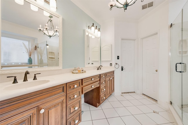 bathroom with an inviting chandelier, a sink, crown molding, and visible vents