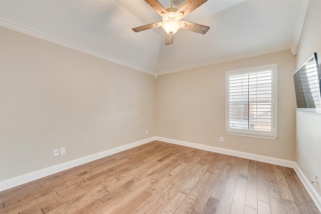 spare room with crown molding, lofted ceiling, baseboards, ceiling fan, and light wood-type flooring