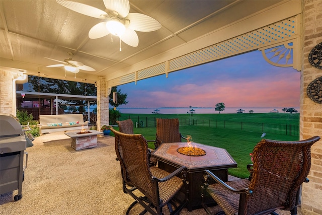 view of patio featuring a fenced backyard, a ceiling fan, an outdoor fire pit, and a grill