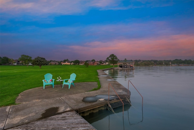 exterior space with a yard, a water view, and a boat dock