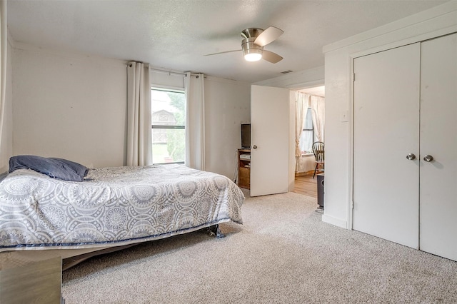 carpeted bedroom featuring ceiling fan