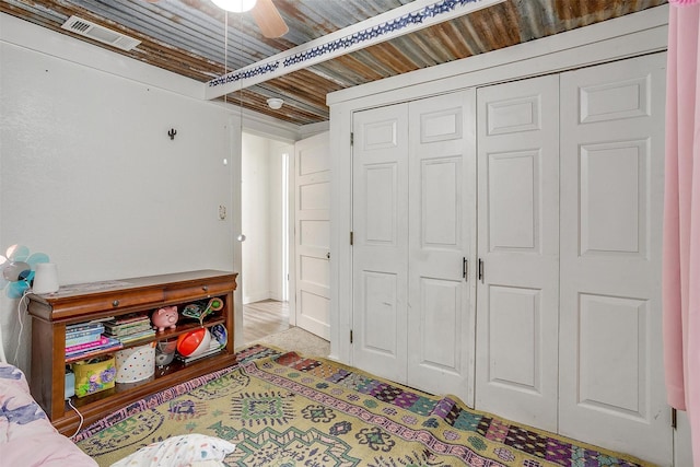 interior space featuring ceiling fan, a closet, and visible vents