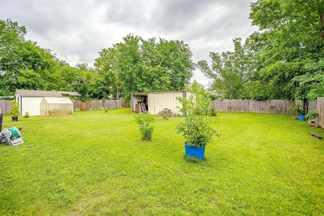 view of yard with a fenced backyard and an outbuilding
