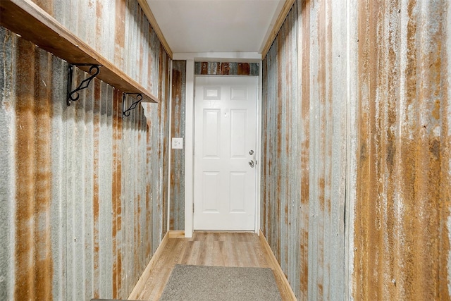 doorway featuring wallpapered walls and wood finished floors