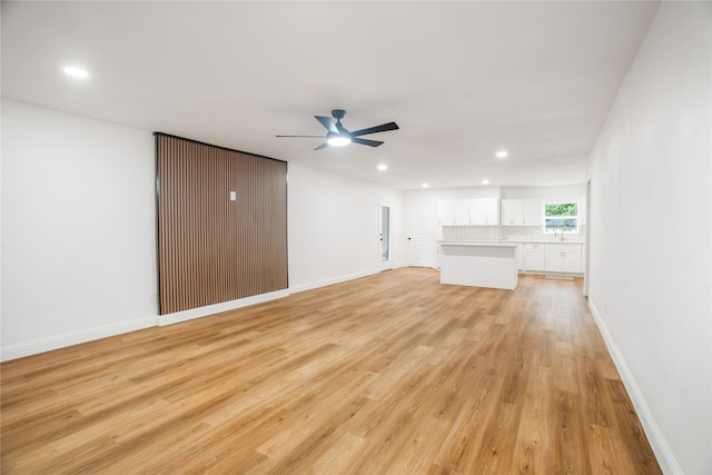 unfurnished living room with recessed lighting, light wood finished floors, ceiling fan, and baseboards
