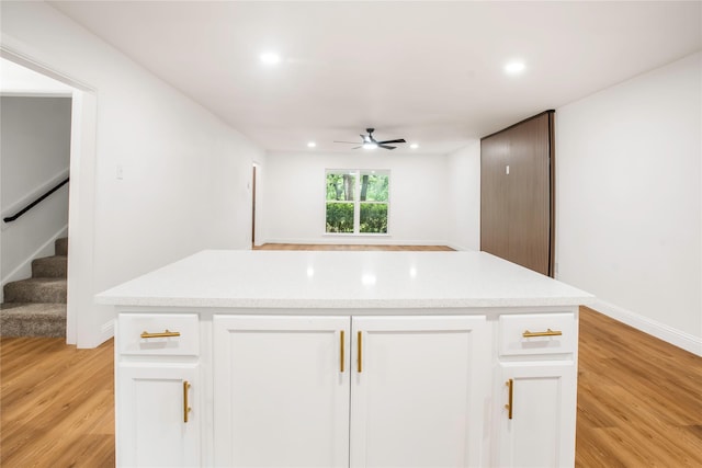 kitchen with a kitchen island, a ceiling fan, light wood-style floors, recessed lighting, and white cabinetry