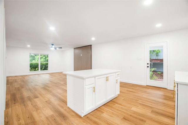 kitchen with light countertops, white cabinets, a ceiling fan, and recessed lighting