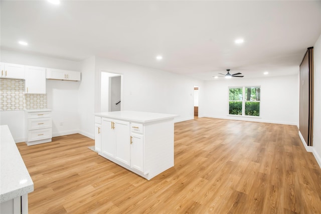 kitchen featuring light countertops, a ceiling fan, recessed lighting, white cabinetry, and light wood-type flooring