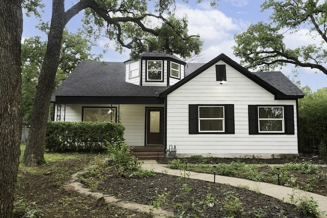 bungalow-style home featuring roof with shingles