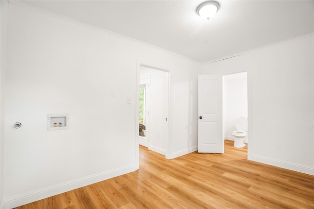 unfurnished room with baseboards, ornamental molding, and light wood-type flooring