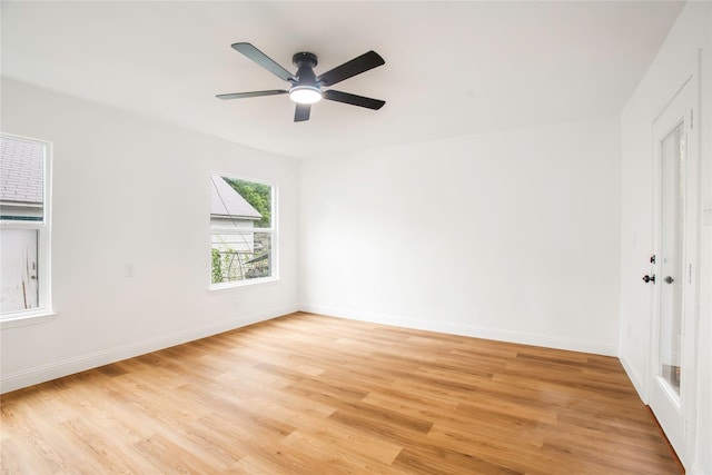 unfurnished bedroom with light wood-type flooring, a ceiling fan, and baseboards