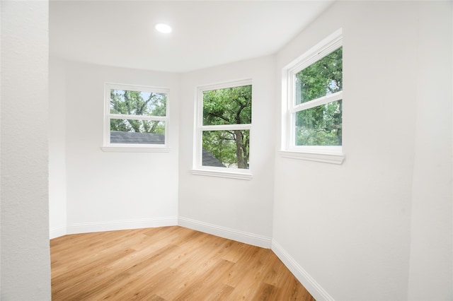 empty room with recessed lighting, baseboards, and light wood-style flooring